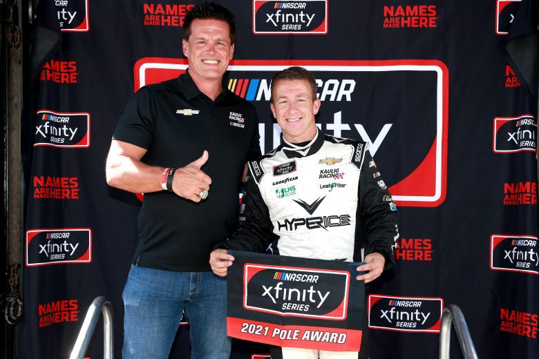 INDIANAPOLIS, INDIANA - AUGUST 14: Matt Kaulig, owner of Kaulig Racing (L) and AJ Allmendinger, driver of the #16 Hyperice Chevrolet, poses for photos after winning the pole award during qualifying for the NASCAR Xfinity Series Pennzoil 150 at the Brickyard at Indianapolis Motor Speedway on August 14, 2021 in Indianapolis, Indiana. (Photo by Sean Gardner/Getty Images) | Getty Images