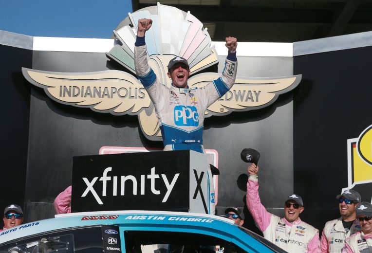 INDIANAPOLIS, INDIANA - AUGUST 14: Austin Cindric, driver of the #22 PPG Ford, celebrates in victory lane after winning the NASCAR Xfinity Series Pennzoil 150 at the Brickyard at Indianapolis Motor Speedway on August 14, 2021 in Indianapolis, Indiana. (Photo by Sean Gardner/Getty Images) | Getty Images