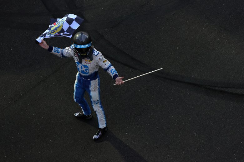 INDIANAPOLIS, INDIANA - AUGUST 14: Austin Cindric, driver of the #22 PPG Ford,celebrates with the checkered flag after winning the NASCAR Xfinity Series Pennzoil 150 at the Brickyard at Indianapolis Motor Speedway on August 14, 2021 in Indianapolis, Indiana. (Photo by Stacy Revere/Getty Images) | Getty Images