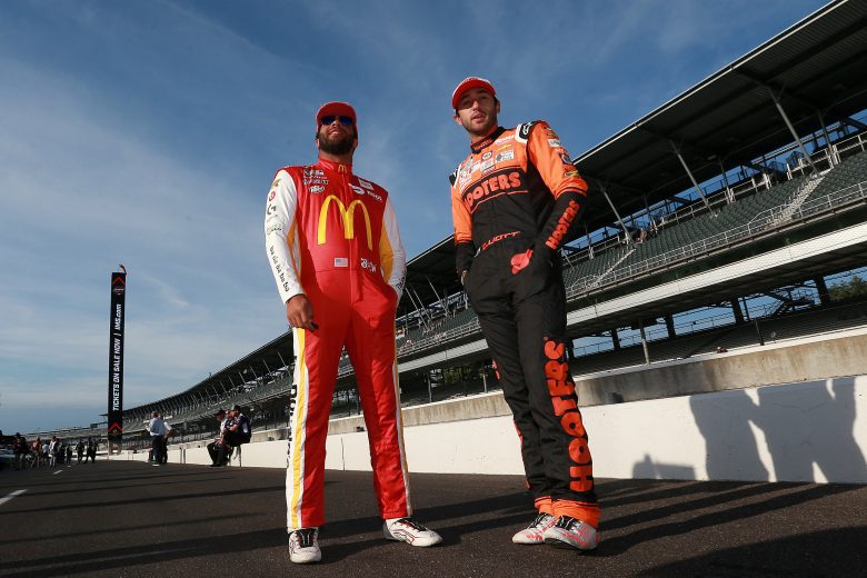 INDIANAPOLIS, INDIANA - AUGUST 15: Bubba Wallace, driver of the #23 McDonald's Toyota, (L) and Chase Elliott, driver of the #9 Hooters Chevrolet, talk on the grid during qualifying for the NASCAR Cup Series Verizon 200 at the Brickyard at Indianapolis Motor Speedway on August 15, 2021 in Indianapolis, Indiana. (Photo by Sean Gardner/Getty Images) | Getty Images
