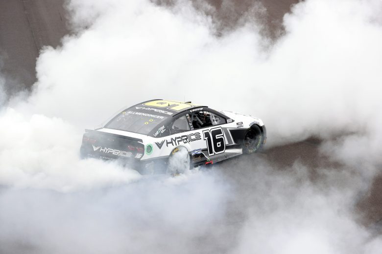 INDIANAPOLIS, INDIANA - AUGUST 15: AJ Allmendinger, driver of the #16 Hyperice Chevrolet, celebrates with a burnout after winning the NASCAR Cup Series Verizon 200 at the Brickyard at Indianapolis Motor Speedway on August 15, 2021 in Indianapolis, Indiana. (Photo by Stacy Revere/Getty Images) | Getty Images