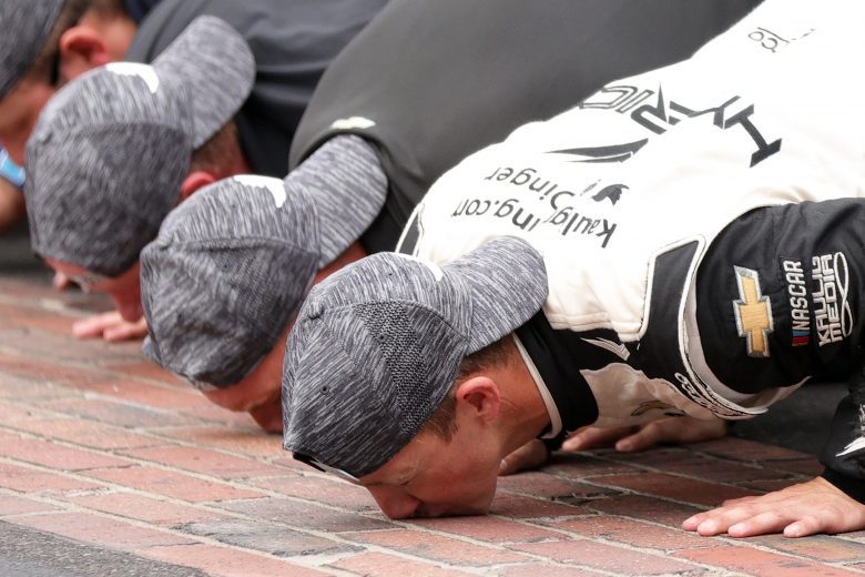 INDIANAPOLIS, INDIANA - AUGUST 15: AJ Allmendinger, driver of the #16 Hyperice Chevrolet, celebrates by kissing the yard of bricks after winning the NASCAR Cup Series Verizon 200 at the Brickyard at Indianapolis Motor Speedway on August 15, 2021 in Indianapolis, Indiana. (Photo by Stacy Revere/Getty Images) | Getty Images
