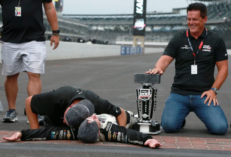 INDIANAPOLIS, INDIANA - AUGUST 15: AJ Allmendinger, driver of the #16 Hyperice Chevrolet, (L) Matt Kaulig, owner of Kaulig Racing and crew celebrate on the yard of bricks after winning the NASCAR Cup Series Verizon 200 at the Brickyard at Indianapolis Motor Speedway on August 15, 2021 in Indianapolis, Indiana. (Photo by Sean Gardner/Getty Images) | Getty Images