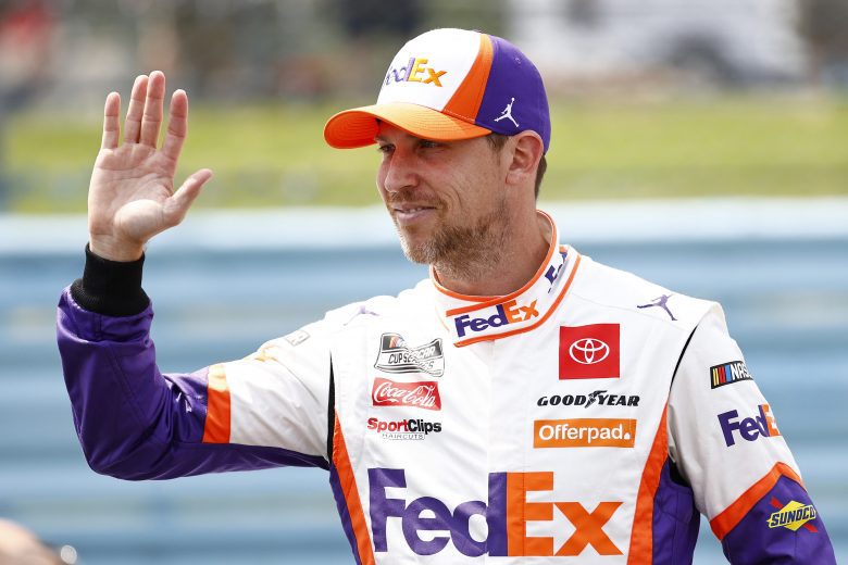 WATKINS GLEN, NEW YORK - AUGUST 08: Denny Hamlin, driver of the #11 FedEx Express Toyota, waves from the grid prior to the NASCAR Cup Series Go Bowling at The Glen at Watkins Glen International on August 08, 2021 in Watkins Glen, New York. (Photo by Jared C. Tilton/Getty Images) | Getty Images