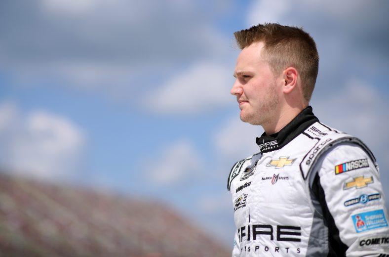 BROOKLYN, MICHIGAN - AUGUST 22: Justin Haley, driver of the #77 General Formulations/Mutoh Chevrolet, walks on stage during driver introductions prior to the NASCAR Cup Series FireKeepers Casino 400 at Michigan International Speedway on August 22, 2021 in Brooklyn, Michigan. (Photo by Sean Gardner/Getty Images) | Getty Images