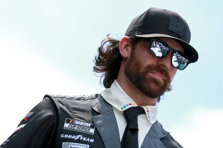 HAMPTON, GEORGIA - JULY 11: Corey LaJoie, driver of the #7 The Boss Baby: Family Business Chevrolet, walks the stage during pre-race ceremonies prior to the NASCAR Cup Series Quaker State 400 presented by Walmart at Atlanta Motor Speedway on July 11, 2021 in Hampton, Georgia. (Photo by Sean Gardner/Getty Images) | Getty Images