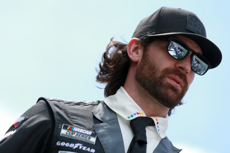 HAMPTON, GEORGIA - JULY 11: Corey LaJoie, driver of the #7 The Boss Baby: Family Business Chevrolet, walks the stage during pre-race ceremonies prior to the NASCAR Cup Series Quaker State 400 presented by Walmart at Atlanta Motor Speedway on July 11, 2021 in Hampton, Georgia. (Photo by Sean Gardner/Getty Images) | Getty Images