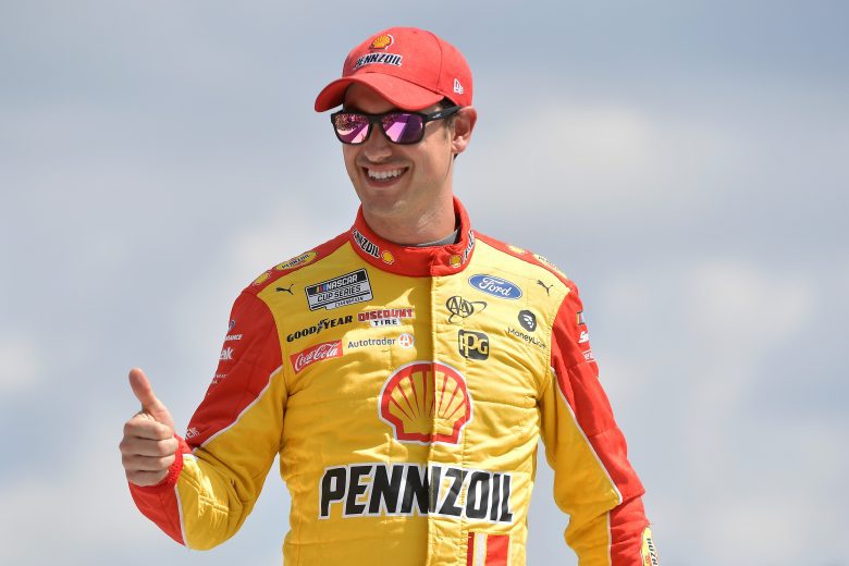 BROOKLYN, MICHIGAN - AUGUST 22: Joey Logano, driver of the #22 Shell Pennzoil Ford, gives a thumbs up on stage during driver introductions prior to the NASCAR Cup Series FireKeepers Casino 400 at Michigan International Speedway on August 22, 2021 in Brooklyn, Michigan. (Photo by Logan Riely/Getty Images) | Getty Images