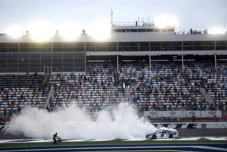 CONCORD, NORTH CAROLINA - OCTOBER 11: Fans cheer as Chase Elliott, driver of the #9 NAPA Auto Parts Chevrolet, celebrates with a burnout after winning the NASCAR Cup Series Bank of America ROVAL 400 at Charlotte Motor Speedway on October 11, 2020 in Concord, North Carolina. (Photo by Jared C. Tilton/Getty Images) | Getty Images