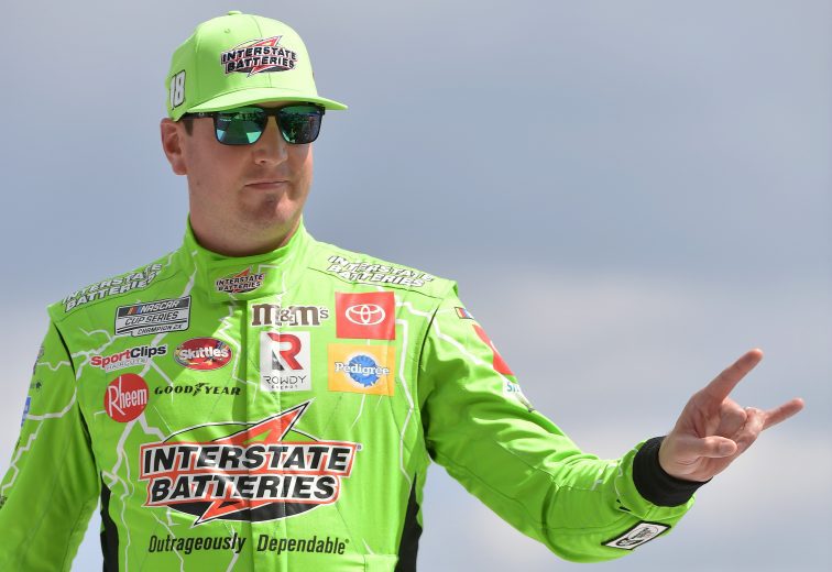 BROOKLYN, MICHIGAN - AUGUST 22: Kyle Busch, driver of the #18 Interstate Batteries Toyota, walks on stage driver introductions prior to the NASCAR Cup Series FireKeepers Casino 400 at Michigan International Speedway on August 22, 2021 in Brooklyn, Michigan. (Photo by Logan Riely/Getty Images) | Getty Images