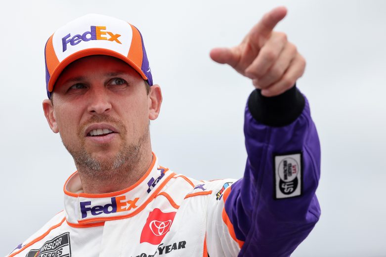LOUDON, NEW HAMPSHIRE - JULY 18: Denny Hamlin, driver of the #11 FedEx Office Toyota, talks to crew on the grid prior to the NASCAR Cup Series  Foxwoods Resort Casino 301 at New Hampshire Motor Speedway on July 18, 2021 in Loudon, New Hampshire. (Photo by James Gilbert/Getty Images) | Getty Images