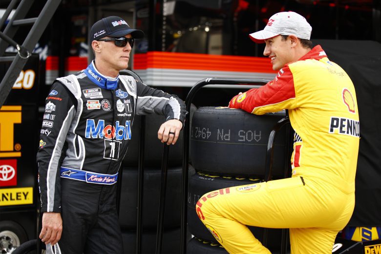 CONCORD, NORTH CAROLINA - MAY 28: Kevin Harvick, driver of the #4 Mobil 1 Ford, and Joey Logano, driver of the #22 Shell Pennzoil Ford, talk in the garage area during practice for the NASCAR Cup Series Coca-Cola 600 at Charlotte Motor Speedway on May 28, 2021 in Concord, North Carolina. (Photo by Jared C. Tilton/Getty Images) | Getty Images