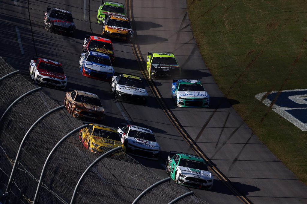 TALLADEGA, ALABAMA - APRIL 25: Brad Keselowski, driver of the #2 MoneyLion Ford, leads Michael McDowell, driver of the #34 Love's Travel Stops Ford, and William Byron, driver of the #24 Liberty University Chevrolet, on the final lao of the NASCAR Cup Series GEICO 500 at Talladega Superspeedway on April 25, 2021 in Talladega, Alabama. (Photo by James Gilbert/Getty Images) | Getty Images