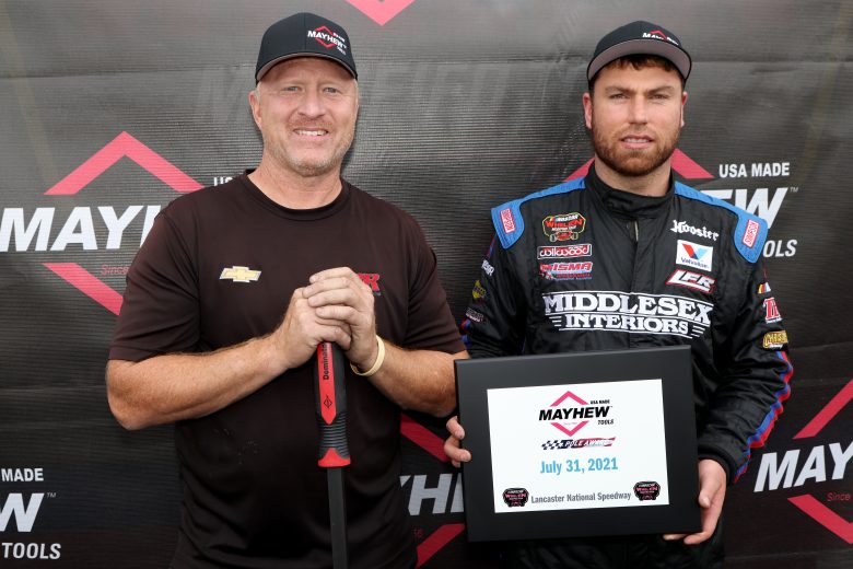 Crew Chief Tommy Baldwin, left, and Jonathan McKennedy, driver of the #7 Ultra Wheel Troyer, pose for a picture after winning the Mayhew Pole Award prior to the Nu Way Auto Parts 150 for the NASCAR Whelen Modified Tour at New York International Raceway Park in Lancaster, New York on July 31, 2021. (Bryan Bennett/NASCAR)