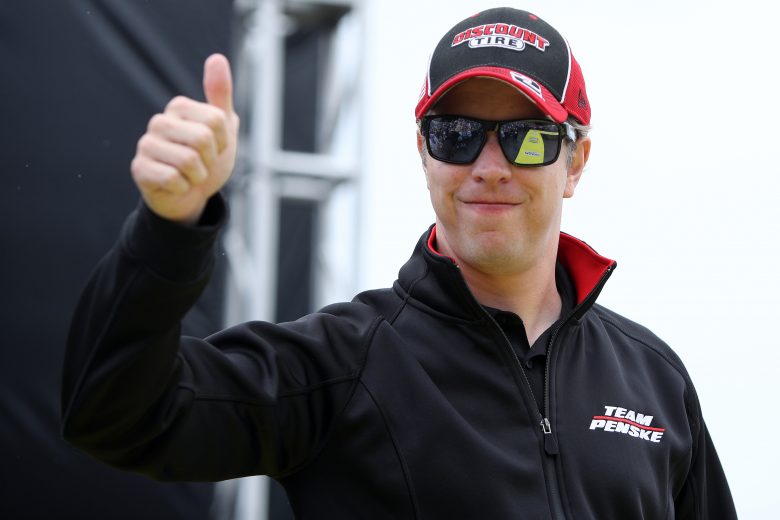 TALLADEGA, ALABAMA - OCTOBER 03: Brad Keselowski, driver of the #2 Discount Tire Ford, gives a thumbs up to fans as he walks on stage during pre-race ceremonies prior to the NASCAR Cup Series YellaWood 500 at Talladega Superspeedway on October 03, 2021 in Talladega, Alabama. (Photo by Sean Gardner/Getty Images) | Getty Images