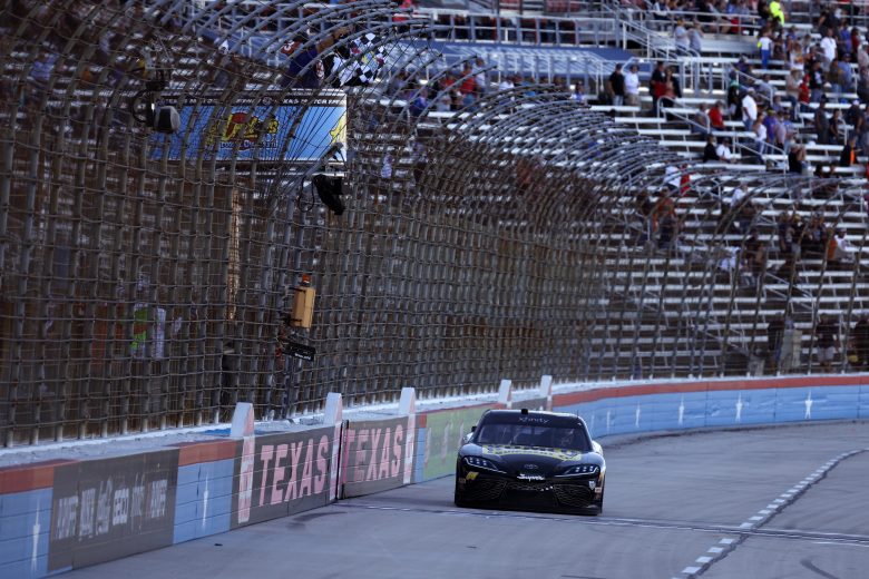 FORT WORTH, TEXAS - OCTOBER 16: John H. Nemechek, driver of the #54 Romco Equipment Toyota, takes the checkered flag to win the NASCAR Xfinity Series Andy's Frozen Custard 335 at Texas Motor Speedway on October 16, 2021 in Fort Worth, Texas. (Photo by Jared C. Tilton/Getty Images) | Getty Images