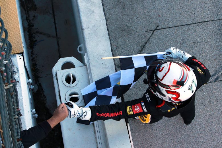 FORT WORTH, TEXAS - OCTOBER 16: John H. Nemechek, driver of the #54 Romco Equipment Toyota, fist bumps an official after receiving the checkered flag for winning the NASCAR Xfinity Series Andy's Frozen Custard 335 at Texas Motor Speedway on October 16, 2021 in Fort Worth, Texas. (Photo by Sean Gardner/Getty Images) | Getty Images