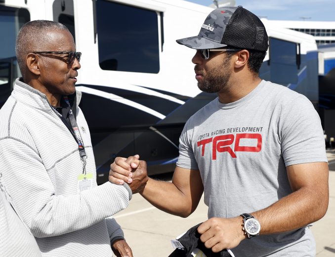 FORT WORTH, TEXAS - OCTOBER 17: Bubba Wallace, driver of the #23 Columbia Toyota, meets with NFL Hall of Famer Tony Dorsett prior to the NASCAR Cup Series Autotrader EchoPark Automotive 500 at Texas Motor Speedway on October 17, 2021 in Fort Worth, Texas. (Photo by Chris Graythen/Getty Images) | Getty Images