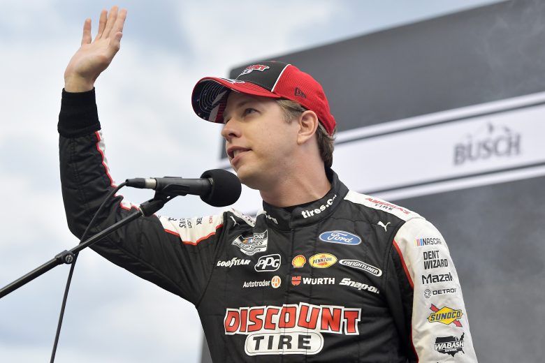 BRISTOL, TENNESSEE - SEPTEMBER 18: Brad Keselowski, driver of the #2 Discount Tire Ford, speaks to fans on stage during pre-race ceremonies prior to the NASCAR Cup Series Bass Pro Shops Night Race at Bristol Motor Speedway on September 18, 2021 in Bristol, Tennessee. (Photo by Logan Riely/Getty Images) | Getty Images