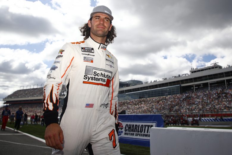 CONCORD, NORTH CAROLINA - OCTOBER 10: Corey LaJoie, driver of the #7 Schluter Systems Chevrolet, walks the grid prior to the NASCAR Cup Series Bank of America ROVAL 400 at Charlotte Motor Speedway on October 10, 2021 in Concord, North Carolina. (Photo by Jared C. Tilton/Getty Images) | Getty Images