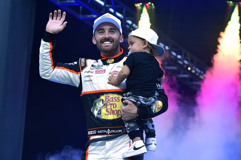 BRISTOL, TENNESSEE - SEPTEMBER 18: Austin Dillon, driver of the #3 Bass Pro Shops/Tracker Off Road Chevrolet, carries his son, Ace R.C  as he walks on stage during pre-race ceremonies prior to the NASCAR Cup Series Bass Pro Shops Night Race at Bristol Motor Speedway on September 18, 2021 in Bristol, Tennessee. (Photo by Logan Riely/Getty Images) | Getty Images