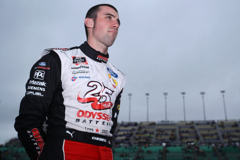 KANSAS CITY, KANSAS - OCTOBER 23: Austin Cindric, driver of the #22 Odyssey Battery Ford, stands on the grid during pre-race ceremonies prior to the NASCAR Xfinity Series Kansas Lottery 300 at Kansas Speedway on October 23, 2021 in Kansas City, Kansas. (Photo by Sean Gardner/Getty Images) | Getty Images