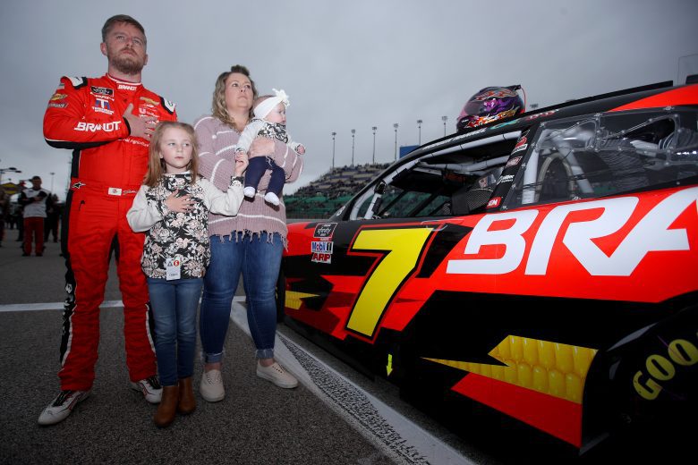 KANSAS CITY, KANSAS - OCTOBER 23: Justin Allgaier, driver of the #7 BRANDT Chevrolet, stands on the grid with his wife, Ashley, and daughters Willow Leigh and Harper during the national anthem on the grid prior to the NASCAR Xfinity Series Kansas Lottery 300 at Kansas Speedway on October 23, 2021 in Kansas City, Kansas. (Photo by Sean Gardner/Getty Images) | Getty Images