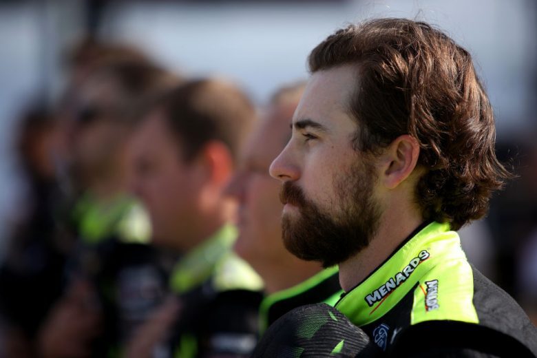 KANSAS CITY, KANSAS - OCTOBER 24: Ryan Blaney, driver of the #12 Menards/Cardell Cabinetry Ford, stands on the grid during pre-race ceremonies prior to the NASCAR Cup Series Hollywood Casino 400 at Kansas Speedway on October 24, 2021 in Kansas City, Kansas. (Photo by Sean Gardner/Getty Images) | Getty Images