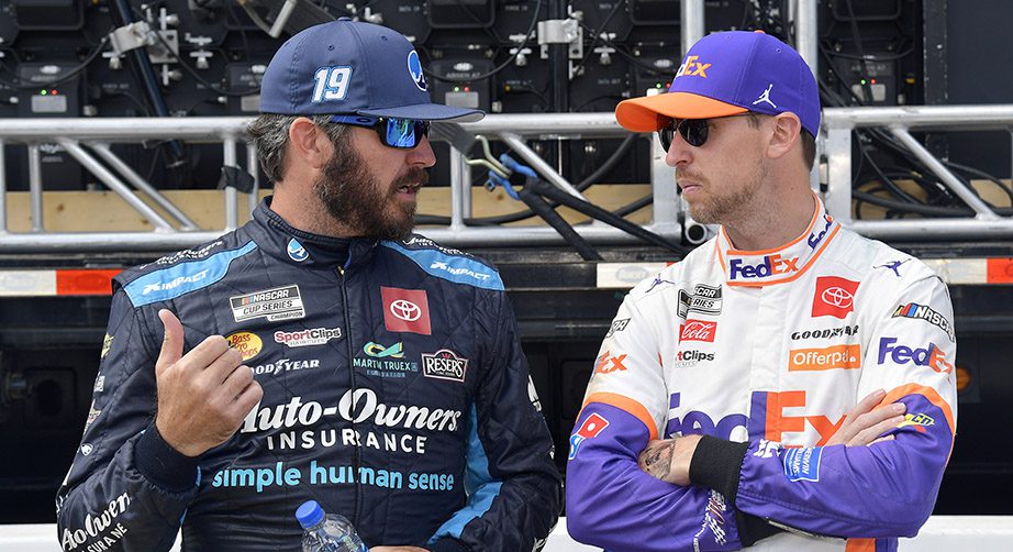 MARTINSVILLE, VIRGINIA - OCTOBER 31: Martin Truex Jr., driver of the #19 Auto-Owners Insurance Toyota, (L) and Denny Hamlin, driver of the #11 FedEx Ground Toyota, talk backstage of pre-race ceremonies prior to the NASCAR Cup Series Xfinity 500 at Martinsville Speedway on October 31, 2021 in Martinsville, Virginia. (Photo by Logan Riely/Getty Images) | Getty Images