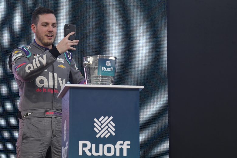 MARTINSVILLE, VIRGINIA - OCTOBER 31: Alex Bowman, driver of the #48 Ally Chevrolet, takes a selfie in the Ruoff Mortgage victory lane after winning the NASCAR Cup Series Xfinity 500 at Martinsville Speedway on October 31, 2021 in Martinsville, Virginia. (Photo by Logan Riely/Getty Images) | Getty Images