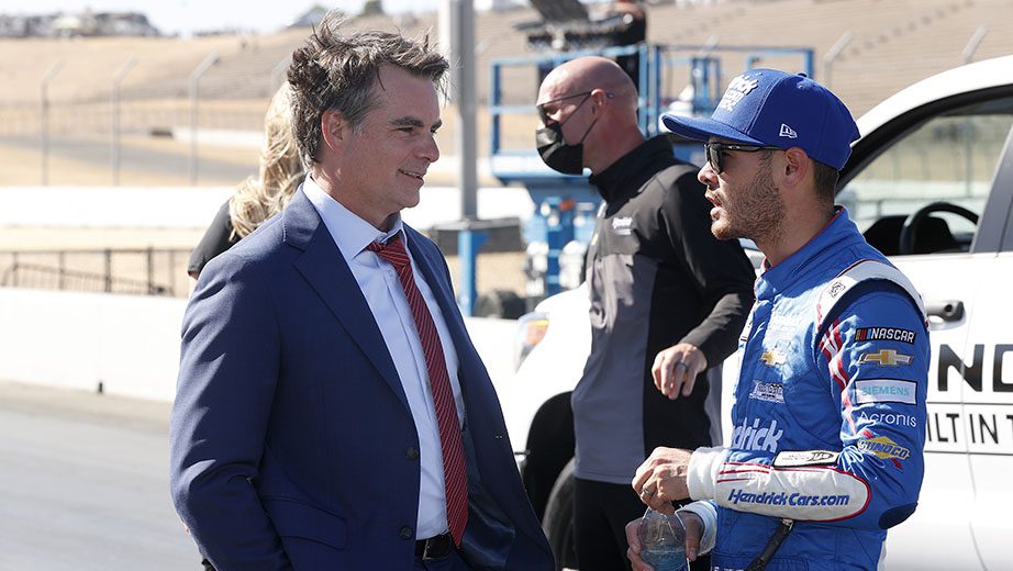 SONOMA, CALIFORNIA - JUNE 06: Kyle Larson, driver of the #5 HendrickCars.com Chevrolet, talks with Hall of Fame driver and TV commentator Jeff Gordon after winning the NASCAR Cup Series Toyota/Save Mart 350 at Sonoma Raceway on June 06, 2021 in Sonoma, California. (Photo by Maddie Meyer/Getty Images) | Getty Images
