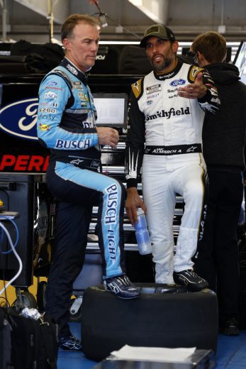 CONCORD, NORTH CAROLINA - NOVEMBER 17: Kevin Harvick driver of the #4 Stewart-Haas Racing Ford talks with Aric Almirola driver of the #10 Stewart-Haas Racing Ford during NASCAR Cup Series Next Gen testing at Charlotte Motor Speedway on November 17, 2021 in Concord, North Carolina. (Photo by Grant Halverson/Getty Images) | Getty Images