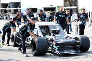 Crew members of Justin Bonsignore, driver of the #51 Phoenix Communications, Inc. Chevrolet, push the car to weigh-ins prior to the Nu Way Auto Parts 150 for the NASCAR Whelen Modified Tour at New York International Raceway Park in Lancaster, New York on July 31, 2021. (Bryan Bennett/NASCAR)