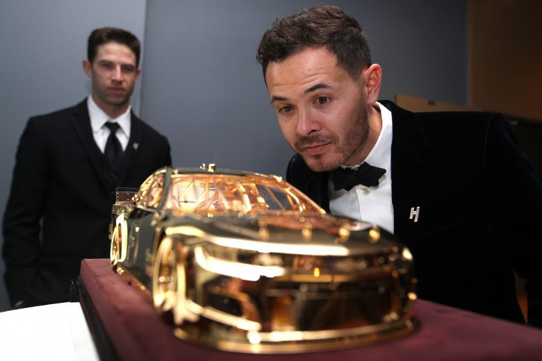 NASHVILLE, TENNESSEE - DECEMBER 01: 2021 NASCAR Cup Series championship driver, Kyle Larson  and his crew chief Cliff Daniels view the Goodyear Gold Car during a reception at The Joseph prior to the NASCAR Champion's Banquet on December 01, 2021 in Nashville, Tennessee. (Photo by Sean Gardner/Getty Images) | Getty Images