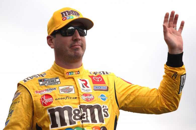 KANSAS CITY, KANSAS - OCTOBER 24: Kyle Busch, driver of the #18 M&M's Halloween Toyota, waves to fans during pre-race ceremonies prior to the NASCAR Cup Series Hollywood Casino 400 at Kansas Speedway on October 24, 2021 in Kansas City, Kansas. (Photo by Sean Gardner/Getty Images) | Getty Images