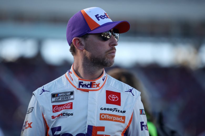 AVONDALE, ARIZONA - NOVEMBER 06: Denny Hamlin, driver of the #11 FedEx Express Toyota, walks the grid during qualifying for the NASCAR Cup Series Championship at Phoenix Raceway on November 06, 2021 in Avondale, Arizona. (Photo by Sean Gardner/Getty Images) | Getty Images