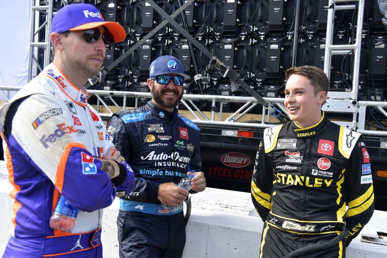 MARTINSVILLE, VIRGINIA - OCTOBER 31:(L-R) Denny Hamlin, driver of the #11 FedEx Ground Toyota, Martin Truex Jr., driver of the #19 Auto-Owners Insurance Toyota, and Christopher Bell, driver of the #20 STANLEY Toyota, talk backstage of pre-race ceremonies prior to the NASCAR Cup Series Xfinity 500 at Martinsville Speedway on October 31, 2021 in Martinsville, Virginia. (Photo by Logan Riely/Getty Images) | Getty Images