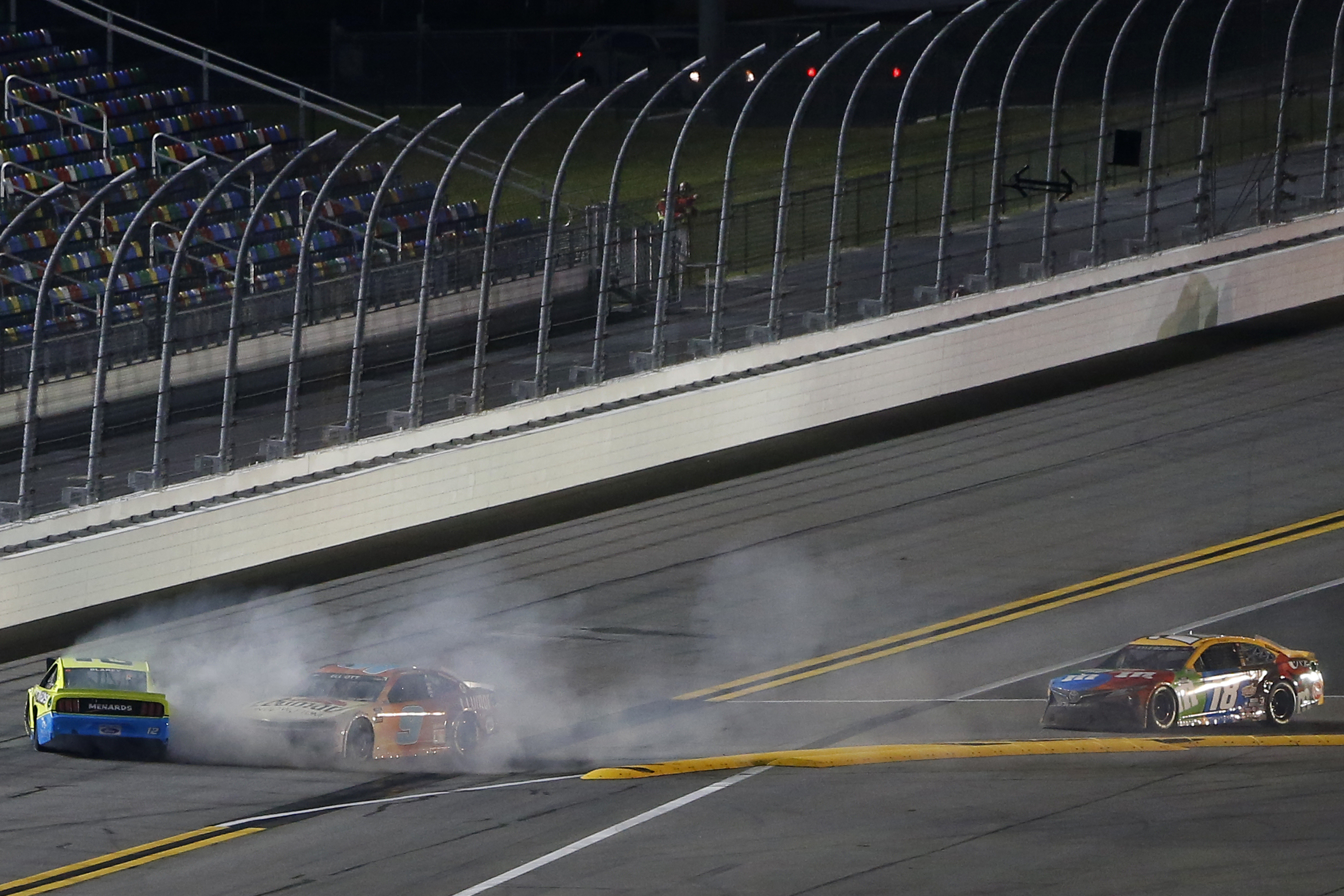 DAYTONA BEACH, FLORIDA - FEBRUARY 09: Ryan Blaney, driver of the #12 Menards/Great Lakes Flooring Ford, and Chase Elliott, driver of the #9 Llumar Chevrolet, wreck as Kyle Busch, driver of the #18 M&M