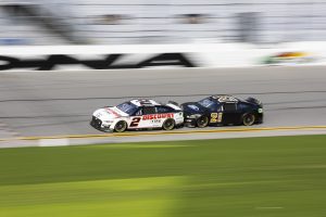 DAYTONA BEACH, FLORIDA - JANUARY 12: #2 Team Penske Ford driver Austin Cindric and #21 Wood Brothers Racing Ford driver Harrison Burton race during the NASCAR Next Gen Test at Daytona International Speedway on January 12, 2022 in Daytona beach, Florida. (Photo by James Gilbert/Getty Images) | Getty Images