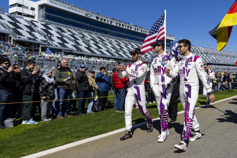 DAYTONA BEACH, FLORIDA - JANUARY 29: Jose Maria Lopez, Jimmie Johnson and Mike Rockenfeller, drivers of the #48 Ally Cadillac Racing Cadillac DPi, walk-on pit lane during prerace before the start of the Rolex 24 at Daytona International Speedway on January 29, 2022 in Daytona Beach, Florida. (Photo by James Gilbert/Getty Images) | Getty Images