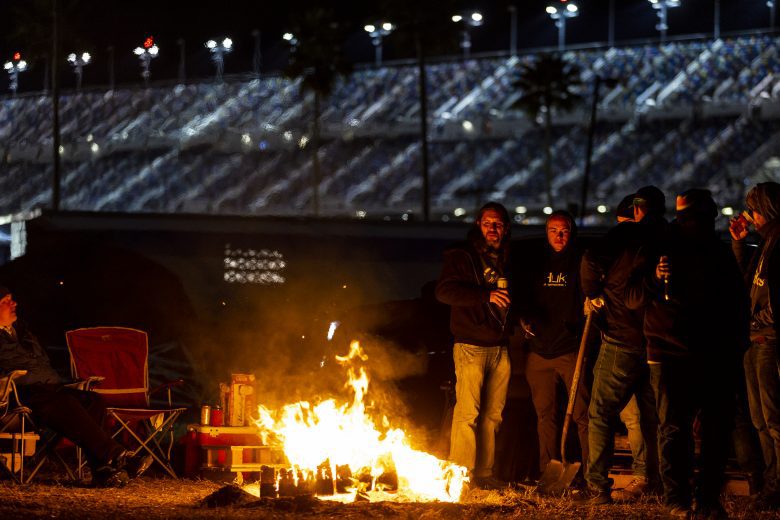 DAYTONA BEACH, FLORIDA - JANUARY 30: Fans stand by a fire during the Rolex 24 at Daytona International Speedway on January 30, 2022 in Daytona Beach, Florida. (Photo by James Gilbert/Getty Images) | Getty Images