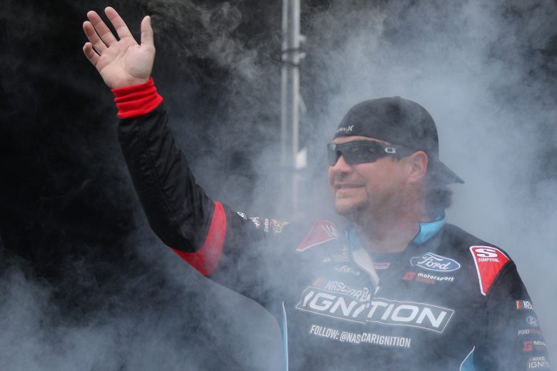 TALLADEGA, ALABAMA - OCTOBER 03: BJ McLeod, driver of the #78 NASCAR 21 Ignition Ford, waves to fans as he walks on stage during pre-race ceremonies prior to the NASCAR Cup Series YellaWood 500 at Talladega Superspeedway on October 03, 2021 in Talladega, Alabama. (Photo by Sean Gardner/Getty Images) | Getty Images