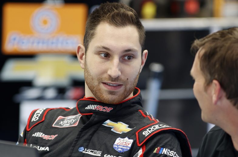CONCORD, NORTH CAROLINA - OCTOBER 11: Kaz Grala driver and a crew member talk in the garage area during the NASCAR Cup Series test at the Charlotte Motor Speedway on October 11, 2021 in Concord, North Carolina. (Photo by Bob Leverone/Getty Images) | Getty Images