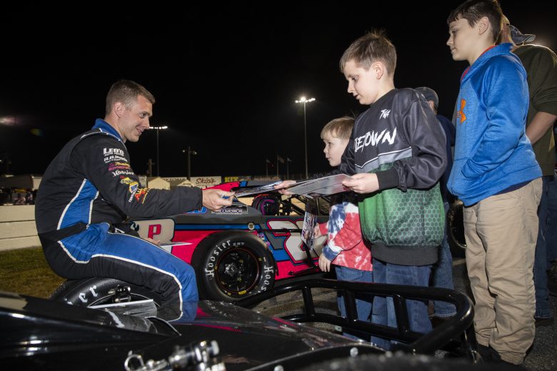 Ron Williams Jr., driver of the #50 Empower Financial Advisory & RB Enterprises Ford, greets young fans during the New Smyrna Visitors Bureau 200 for the NASCAR Whelen Modified Tour during night 2 of the World Series of Asphalt Stock Car Racing at New Smyrna Speedway in New Smyrna, Florida on February 12, 2022. (Adam Glanzman/NASCAR)