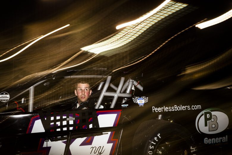 J B Fortin, driver of the #34 Johns Fuel, Whip city Jerky, Johns Tree Removal, Golden Jalapeno Chevrolet, looks on before the New Smyrna Visitors Bureau 200 for the NASCAR Whelen Modified Tour during night 2 of the World Series of Asphalt Stock Car Racing at New Smyrna Speedway in New Smyrna, Florida on February 12, 2022. (Adam Glanzman/NASCAR)