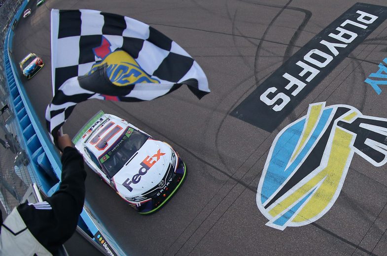 AVONDALE, ARIZONA - NOVEMBER 10: Denny Hamlin, driver of the #11 FedEx Ground Toyota, takes the checkered flag to win the Monster Energy NASCAR Cup Series Bluegreen Vacations 500 at ISM Raceway on November 10, 2019 in Avondale, Arizona. (Photo by Matt Sullivan/Getty Images) | Getty Images