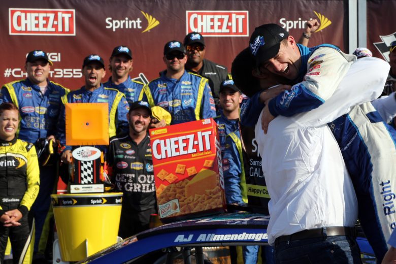 WATKINS GLEN, NY - AUGUST 10:  AJ Allmendinger, driver of the #47 Scott Products Chevrolet, right, celebrates with team owner Brad Daugherty in Victory Lane after winning the NASCAR Sprint Cup Series Cheez-It 355 at Watkins Glen International on August 10, 2014 in Watkins Glen, New York.  (Photo by Jerry Markland/Getty Images) | Getty Images