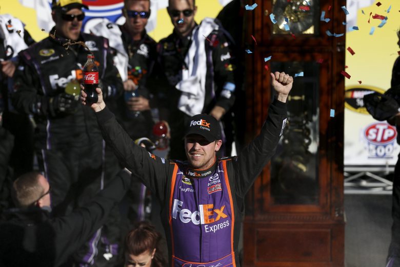 Denny Hamlin, driver of the #11 Sport Clips Toyota,  celebrates in victory lane after winning during the NASCAR Sprint Cup Series STP 500 at Martinsville Speedway on March 29, 2015 in Martinsville, Virginia.