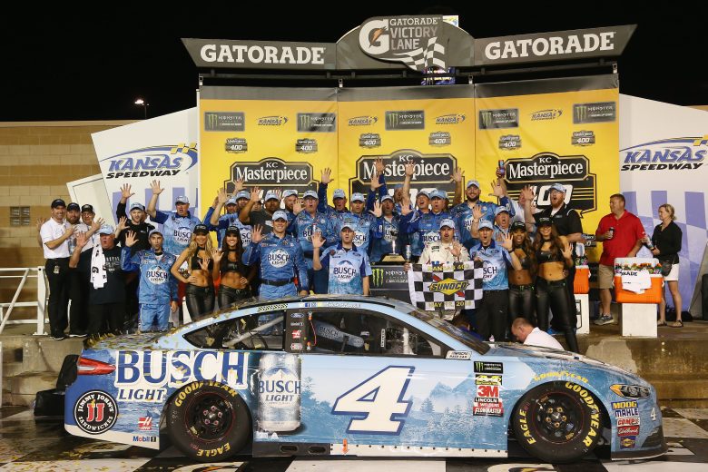 KANSAS CITY, KS - MAY 12:  Kevin Harvick, driver of the #4 Busch Light Ford, and his team celebrate in victory lane after winning the Monster Energy NASCAR Cup Series KC Masterpiece 400 at Kansas Speedway on May 12, 2018 in Kansas City, Kansas.  (Photo by Sarah Crabill/Getty Images) | Getty Images