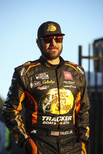LOS ANGELES, CALIFORNIA - FEBRUARY 05: Martin Truex Jr., driver of the #19 Bass Pro Shops Toyota, walks the grid during qualifying for the NASCAR Cup Series Busch Light Clash at Los Angeles Memorial Coliseum on February 05, 2022 in Los Angeles, California. (Photo by Meg Oliphant/Getty Images)